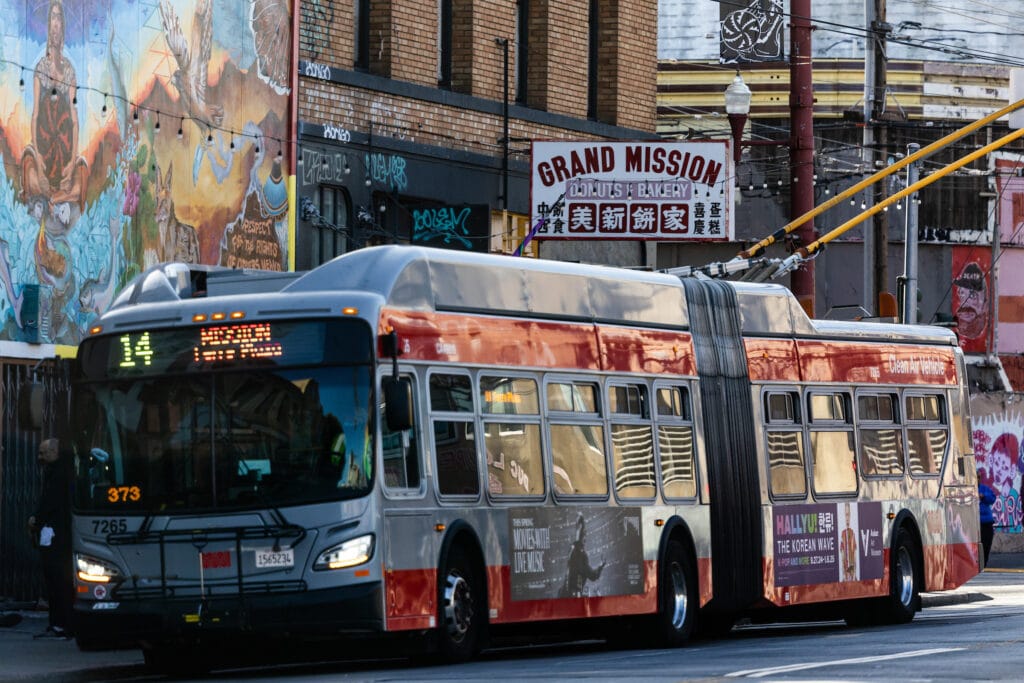 City bus and mural in Mission District, San Francisco CA